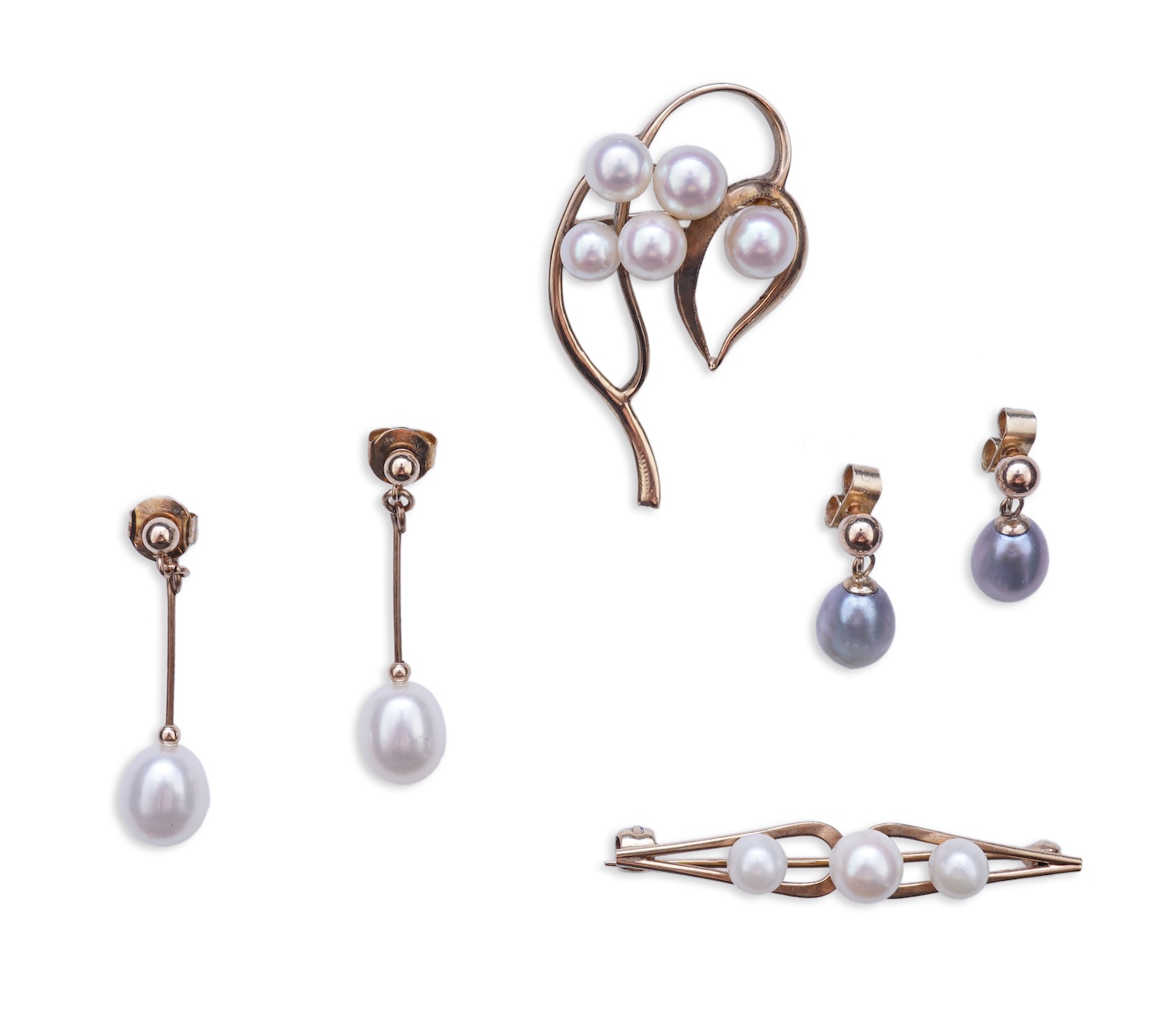 A group of cultured pearl jewels, comprising: two pairs of cultured pearl drop earrings, longest 3cm, mounted in gold; and two cultured pearl brooches mounted in 9ct gold, longest 4.1cm, British hallmarks, combined gross